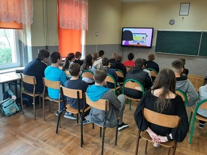 spotkanie policjanta z uczniami, klasa uczniowie w ławkach