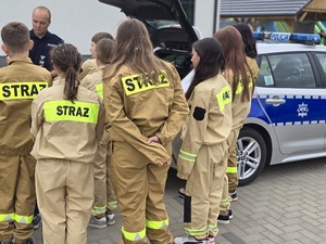 promocja zawodu policjanta na pikniku ohp w Budzowie w dniu 10.05.2025 , policjanci umundurowani z młodzieżą przy radiowozie