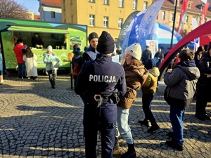policjantka podczas Przebojowej Zimy z Radiem Zet na ząbkowickim Rynku rozdaje dzieciom odblaski