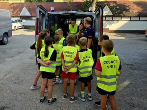 spotkanie policjantki z dziećmi w ramach działań bezpieczne wakacje